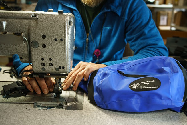 John Peterka sewing a dry bag at the Sagebrush Dry Gear workshop